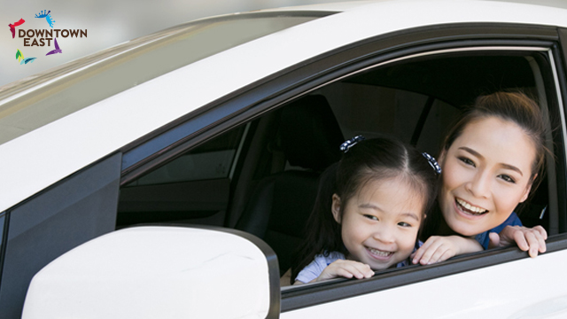 Mother and child looking out of ca smiling